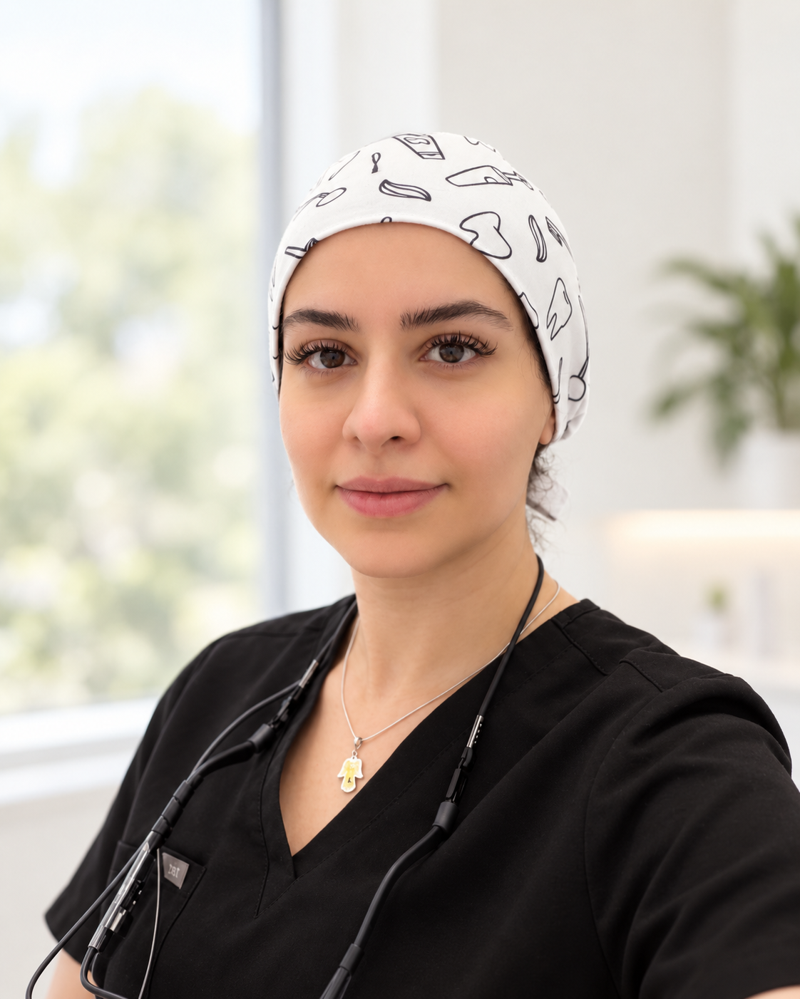 Dr. Sana in black scrubs and a patterned surgical cap